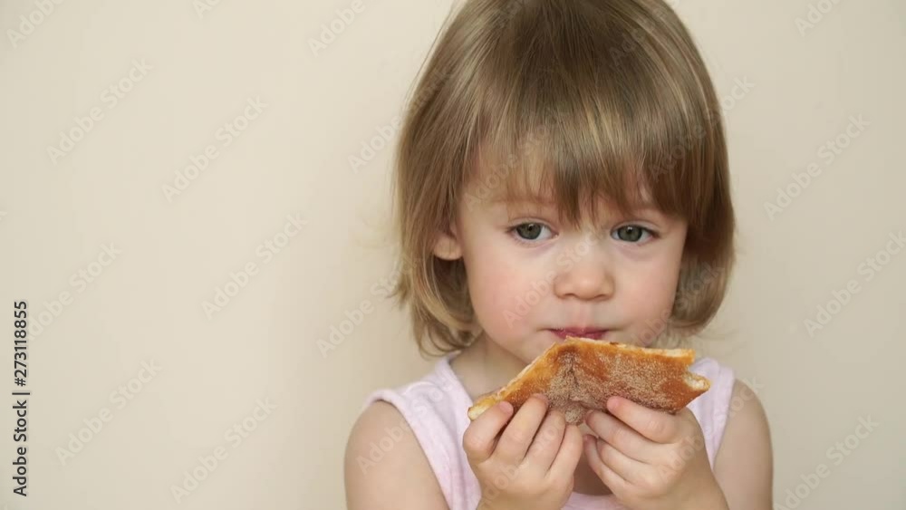 Close up of little cute blonde child girl bites off with big appetite piece of tasty pizza Close up of little cute blonde child girl bites off with big appetite piece of tasty pizza