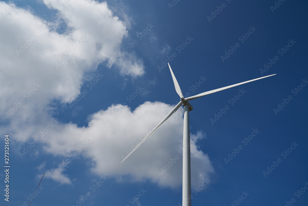 Big windmill in the blue sky and cloud of midday 