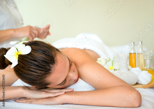Beautiful young Asian woman sleep relaxing in the Oil spa massage in salon.