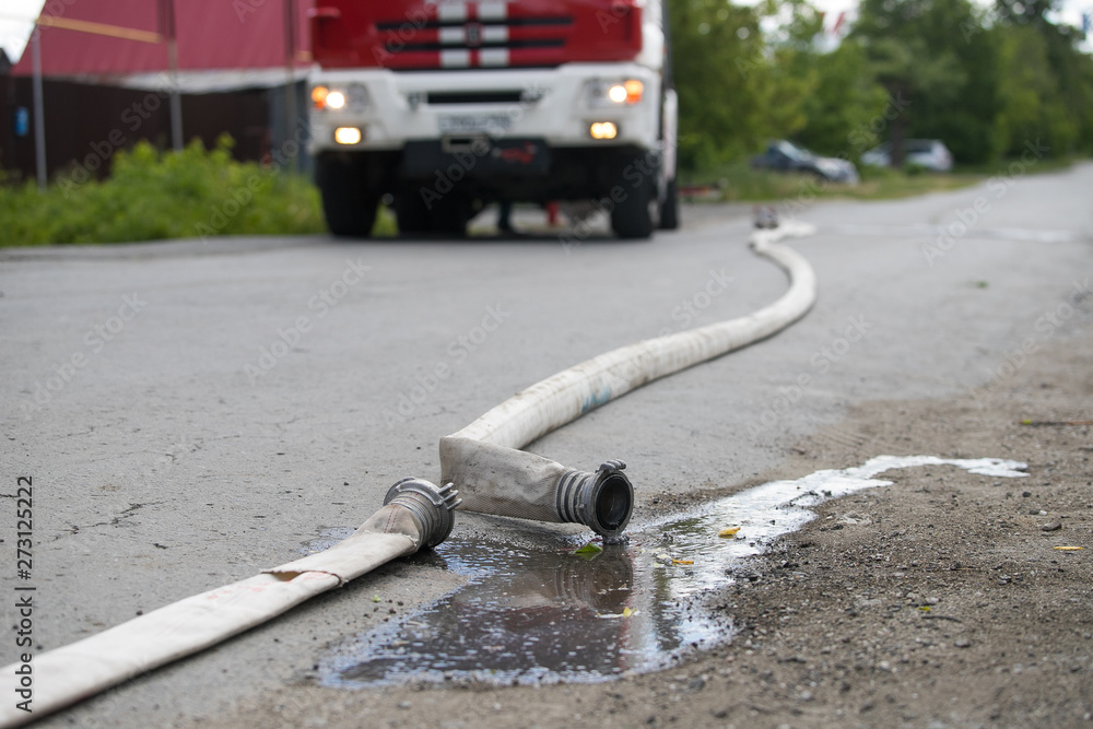 Naklejka premium Fire extinguishing equipment. Fire hose with a water distribution system. Triple valve for supplying water to hoses. Fire extinguishing equipment.