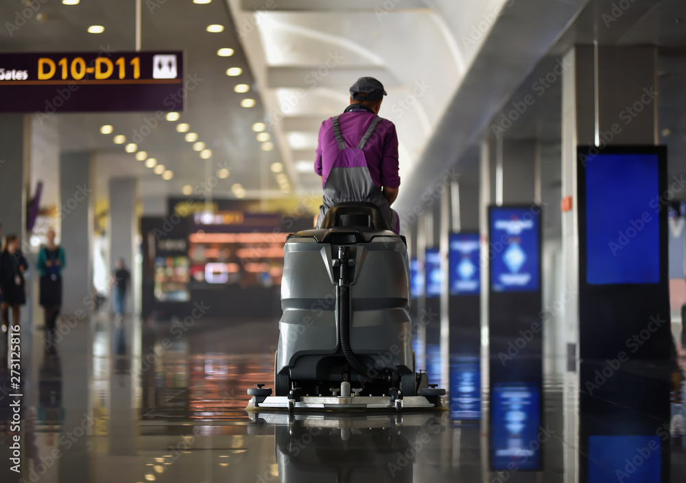 machine of floor scrubber with cleaner man in airport machine of floor scrubber with cleaner man in airport