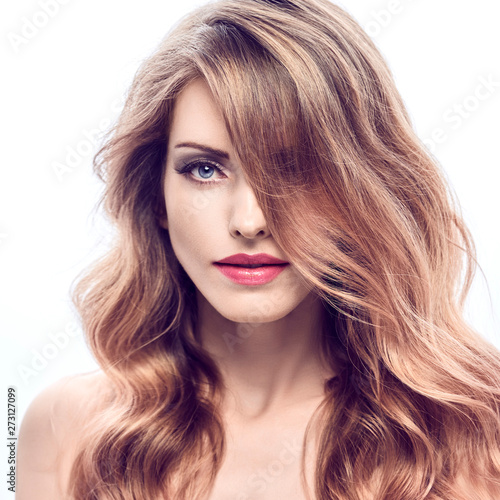 Beautiful fashion woman with perfect healthy skin, trendy wavy hairstyle, fashionable makeup smiling. Gorgeous blonde girl with styling shiny wavy hair. Beauty portrait. Skincare make up concept