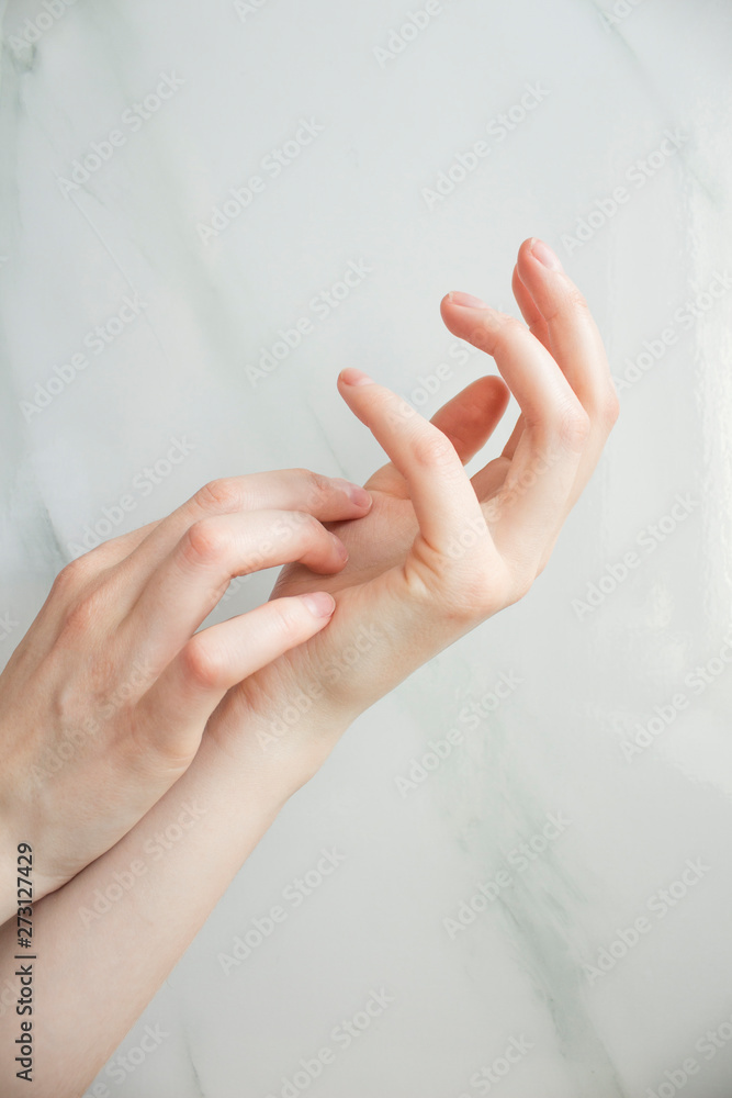 Closeup shot of beautiful woman's hands with cream, white background.Young woman cares about her hands, applying cream on them. Copy space, close up, background, flat lay, top view. Closeup shot of beautiful woman's hands with cream, white background.Young woman cares about her hands, applying cream on them. Copy space, close up, background, flat lay, top view.