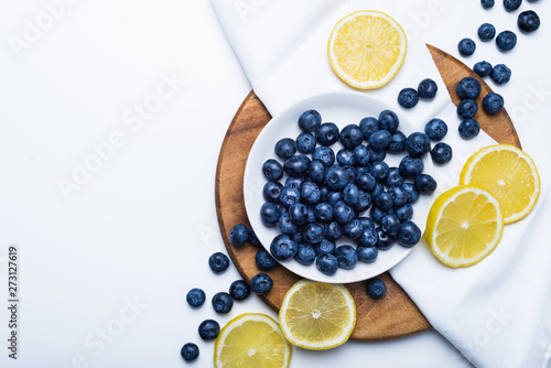 Fresh blueberries and lemon slices, top view
