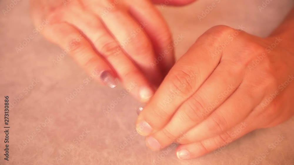 close up of female hands removing nails removing enlarged nails at home close up of female hands removing nails removing enlarged nails at home