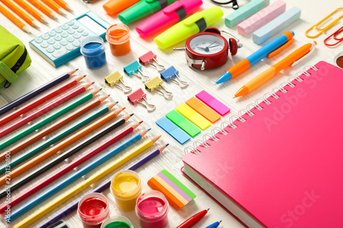 Flat lay composition with school supplies on white wooden background