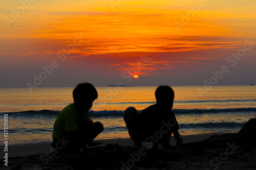 Playing sand at beach in the evening