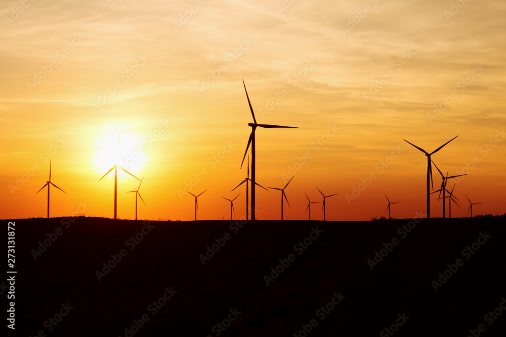 Obraz premium Wind Turbines Over Sunset Sky Generating Electricity. Sustainable Energy Power Generators, Renewable Power Supply