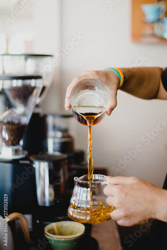 bartender pouring cocktail into glass