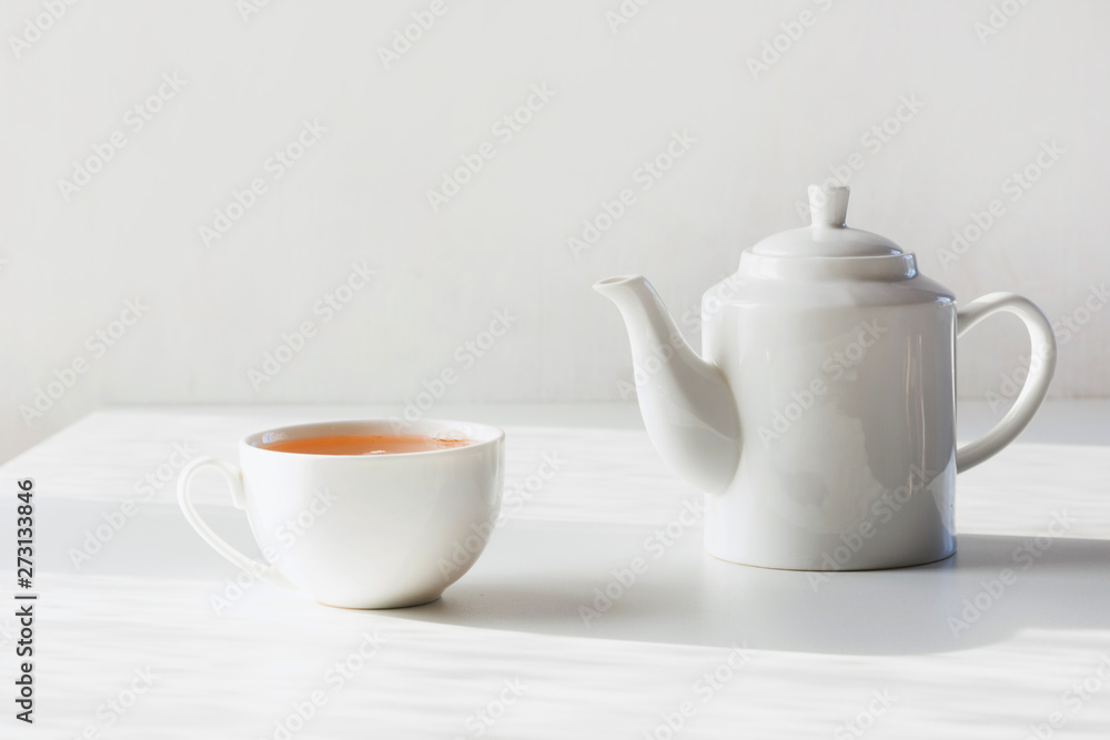 Time for tea. Set of cup and teapot on white. Minimal composition. Time for tea. Set of cup and teapot on white. Minimal composition.