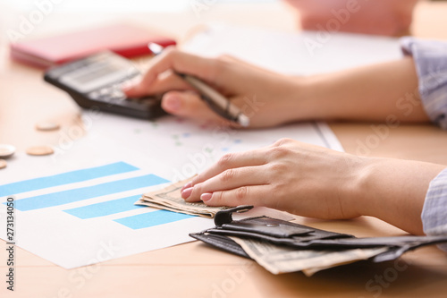 Young woman counting income...