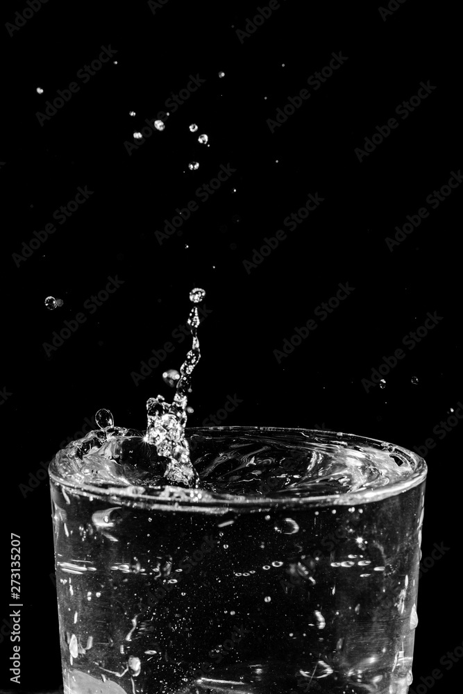 water drops splashing in the glass of water