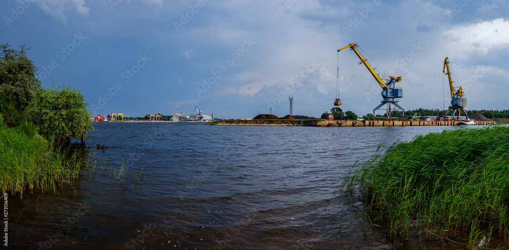 storm clouds forming over Riga cargo shipping port on river Daugava