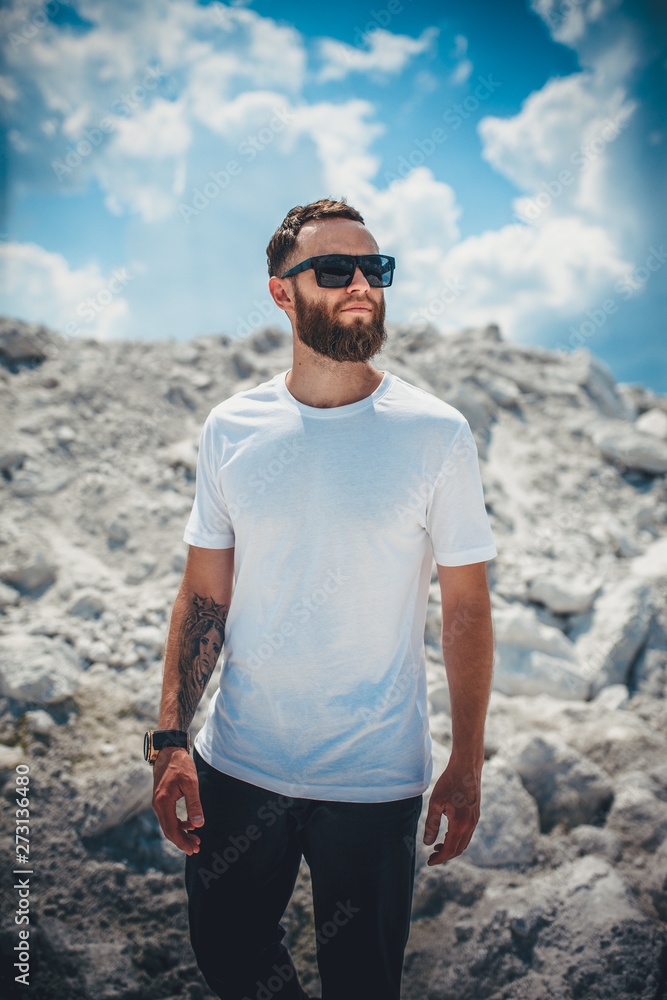 Handsome hipster man with beard wearing white blank t-shirt with space for your logo or design. Handsome hipster man with beard wearing white blank t-shirt with space for your logo or design.