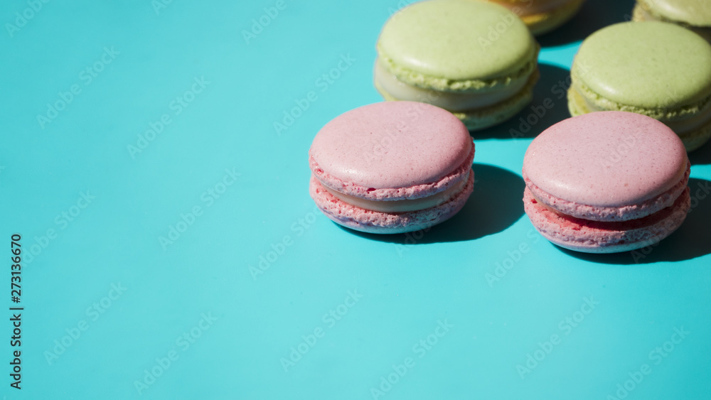 Pink and green macaroons on turquoise backdrop Pink and green macaroons on turquoise backdrop