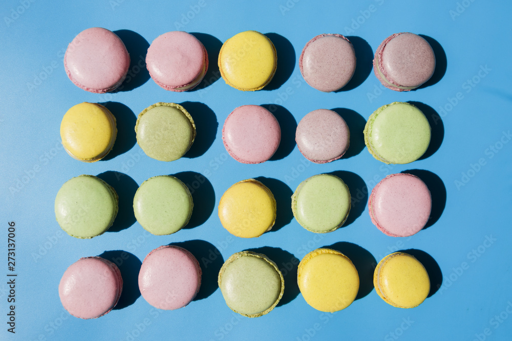 An overhead view of macaroons on blue background An overhead view of macaroons on blue background