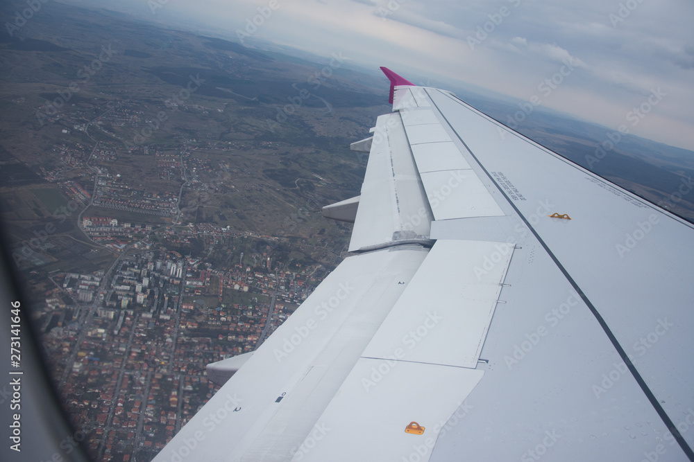 An airplane window view of wing and flaps 