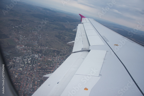 An airplane window view of wing and flaps 