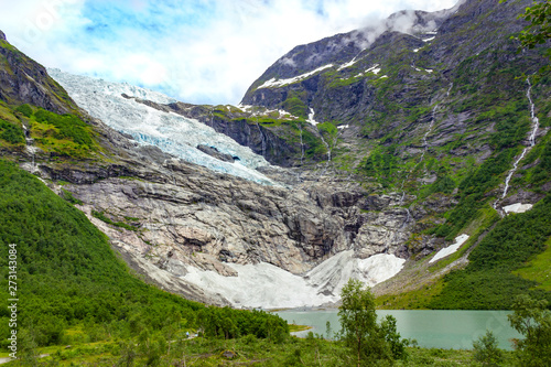 Landscape with river near Briksdal or Briksdalsbreen glacier in Olden  Norway with green mountain. Norway nature and travel background. Summer in Norway  glacier Briksdalsbreen