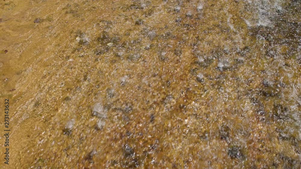 A TILT UP SHOT of a beautiful location in a canyon with a stream and waterfall. SLOW MOTION. A TILT UP SHOT of a beautiful location in a canyon with a stream and waterfall. SLOW MOTION.