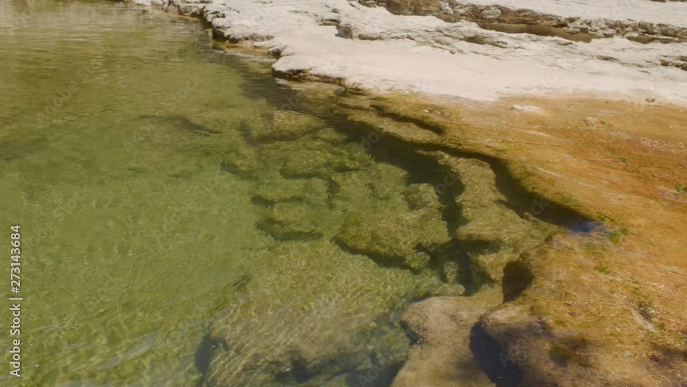 A PANNING SHOT of a beautiful stream flowing through a canyon. SLOW MOTION. A PANNING SHOT of a beautiful stream flowing through a canyon. SLOW MOTION.