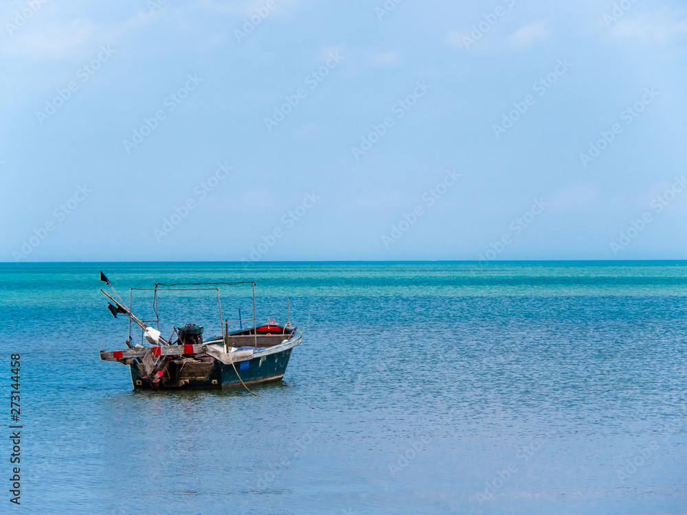 Unmanned small boat on the ocean – seascape with copy space