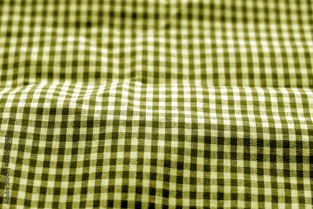 Checked fabric texture in blur effect in yellow tone.