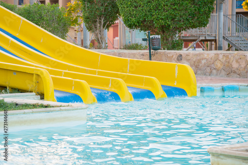 Colourful plastic slides in aquapark in the sunset. sliders  water park