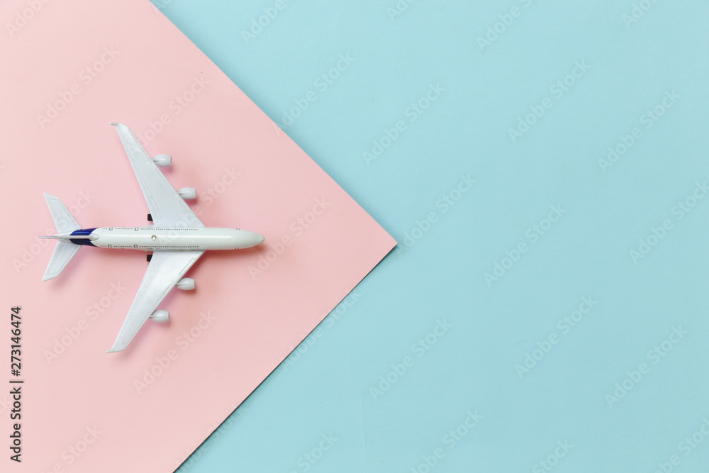 Aircraft toy on pink and blue background. Summer vacation minimal concept.