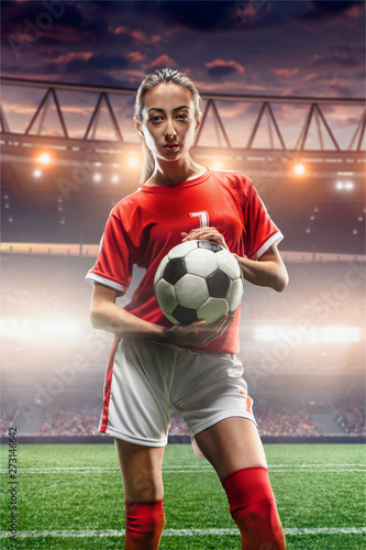 Female Soccer player with ball on a professional soccer stadium