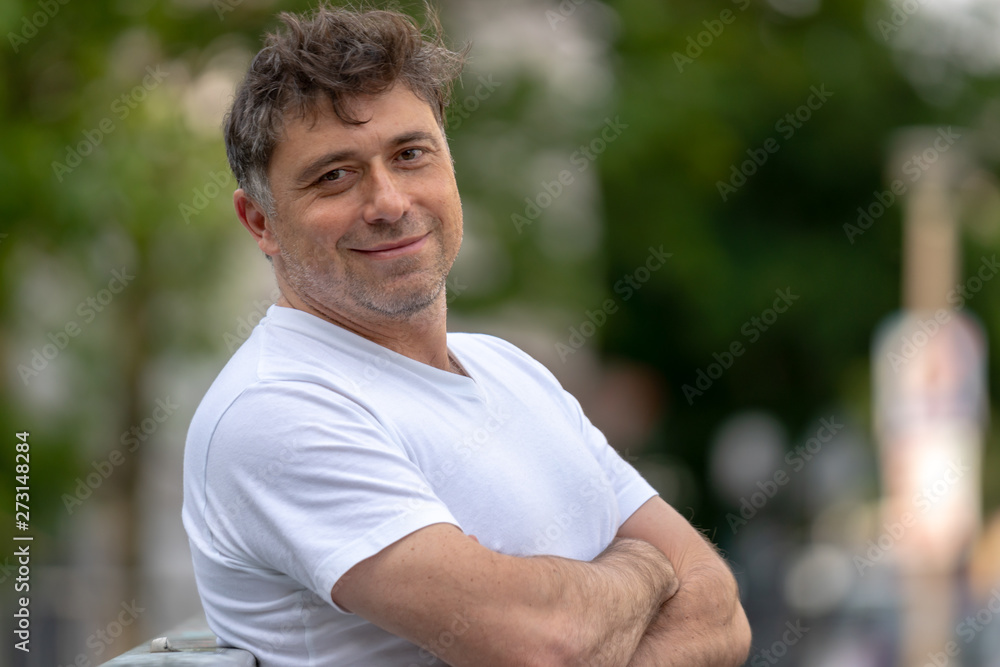 Confident and happy looking man looking at the camera outdoors Confident and happy looking man looking at the camera outdoors