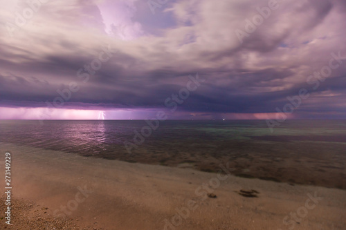 dramatic clouds scape in a thunderstorm with lightnings in the dark night sky photography with long exposer