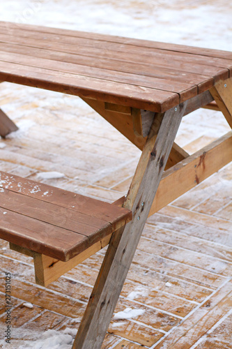 wooden street table and  benches for picnic outdoors in winter on snowy ground © Наталия Чубакова