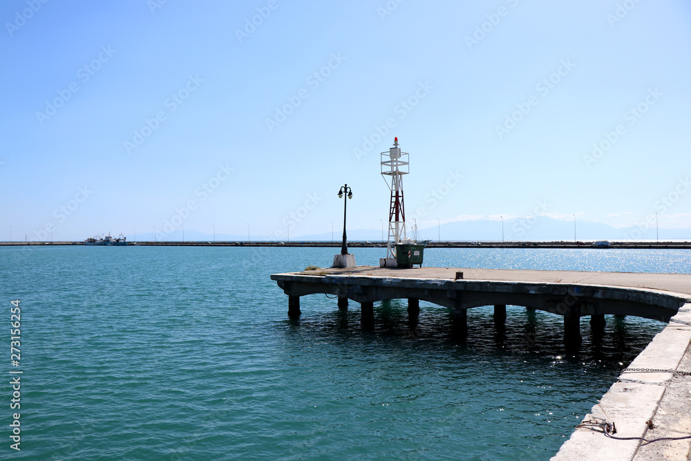 View of Nea Michaniona port, suburb of Thessaloniki, Greece. Pier and lighthouse. 