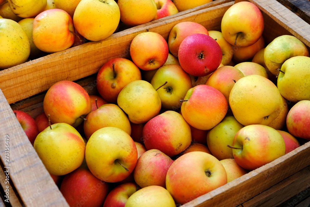 Organic ripe juicy apples in wooden box at farmers market Organic ripe juicy apples in wooden box at farmers market
