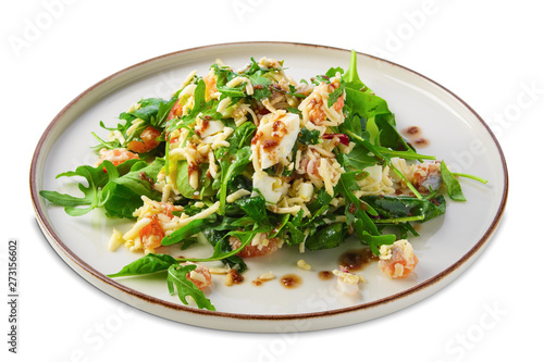 Salad with shrimps, arugula, cucumber, cheese and balsamic sauce isolated on white