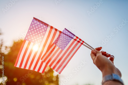 Fototapeta Woman holding USA flag. Celebrating Independence Day of America