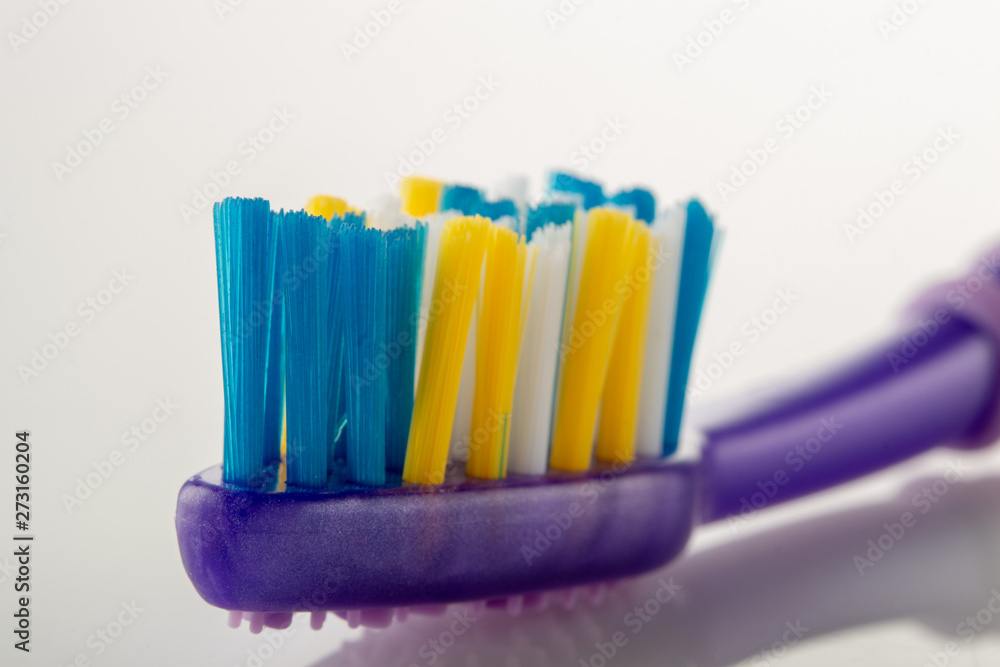 Purple toothbrush head on white background close-up Purple toothbrush head on white background close-up
