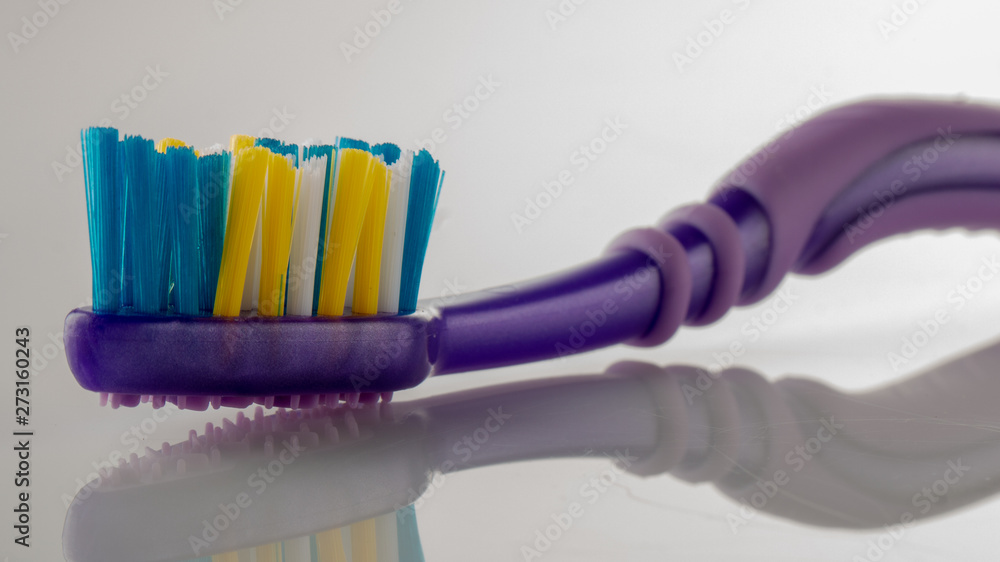 Purple toothbrush head on white background close-up Purple toothbrush head on white background close-up