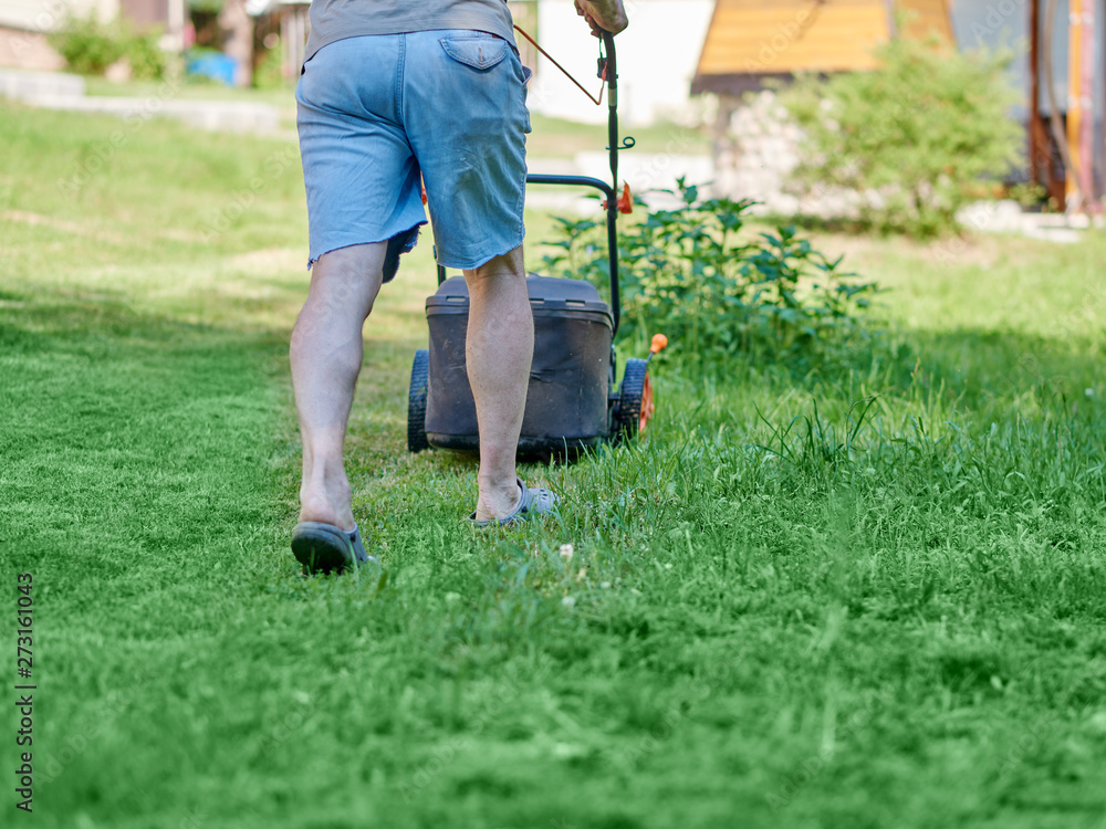 Country works on the personal plot using lawn mower. Country works on the personal plot using lawn mower.