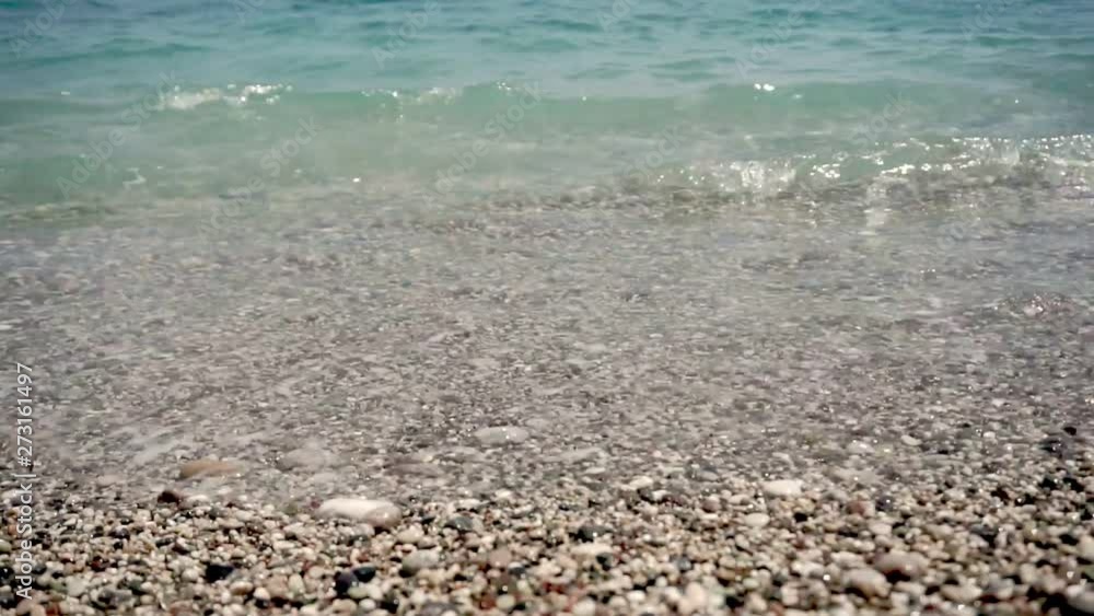 Beautiful sea beach with pebbles close-up, sea surf Beautiful sea beach with pebbles close-up, sea surf