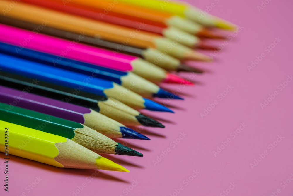 Color Pencils on a pink paper background. Selective focus ,With copy space Color Pencils on a pink paper background. Selective focus ,With copy space