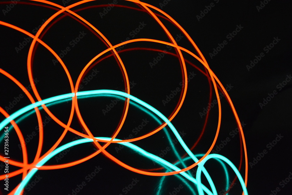 Neon green and red thin wire. Luminous wires, decoration and illumination of the surface. Electroluminescent wire, lighting objects and light base. Neon green and red thin wire. Luminous wires, decoration and illumination of the surface. Electroluminescent wire, lighting objects and light base.