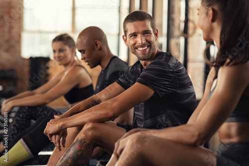 Happy fitness class resting in conversation