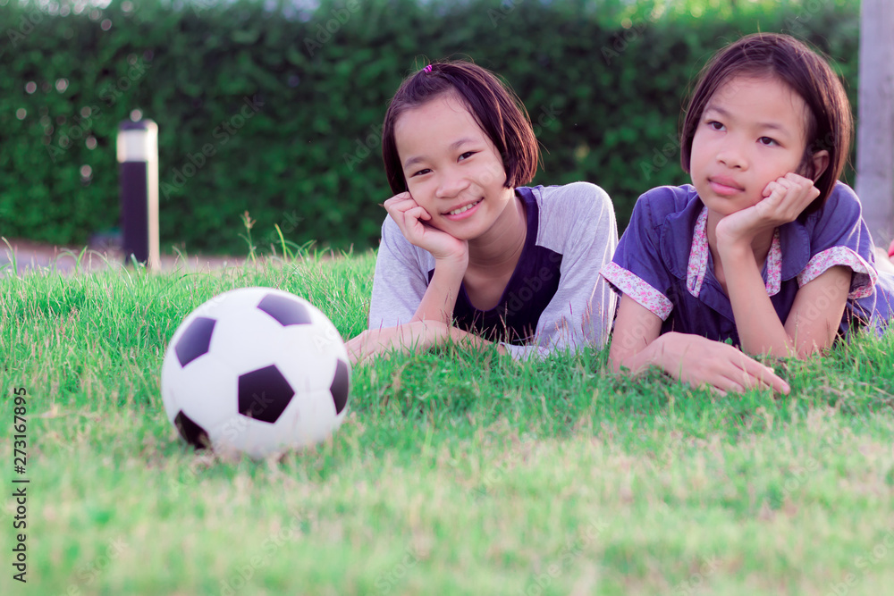 Obraz premium Happy funny sisters twins child. asian little girl in park at thailand