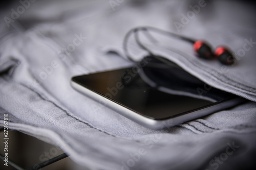 Mobile Phone with earphones . Close Up