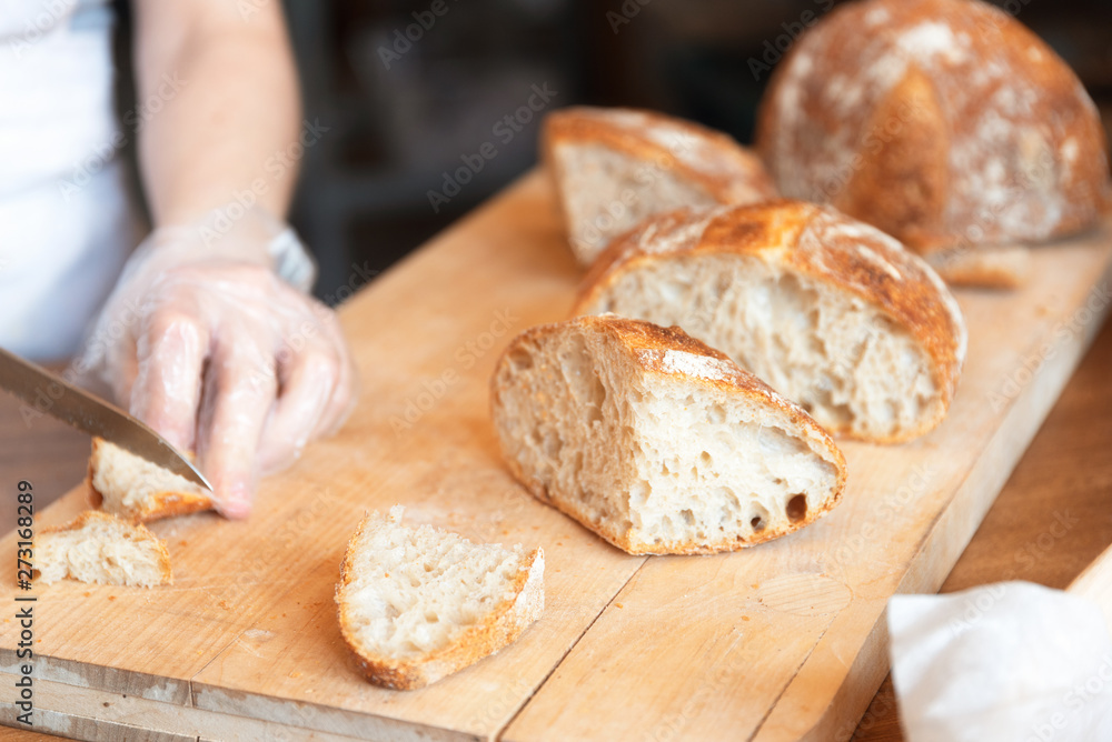 Freshly baked sliced bread on a wooden background