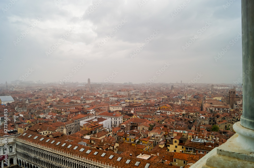 Beautiful aerial view of the red rooftops in an Italian city during a foggy day