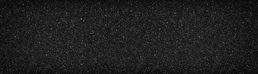 Black stone wall wide texture. Anthracite surface panorama. Dark pebble dash panoramic background