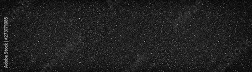 Black stone wall wide texture. Anthracite surface panorama. Dark pebble dash panoramic background